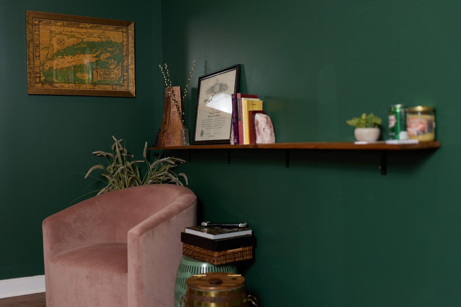 A velvet armchair against the deep green wall of the Galbo Family Law office