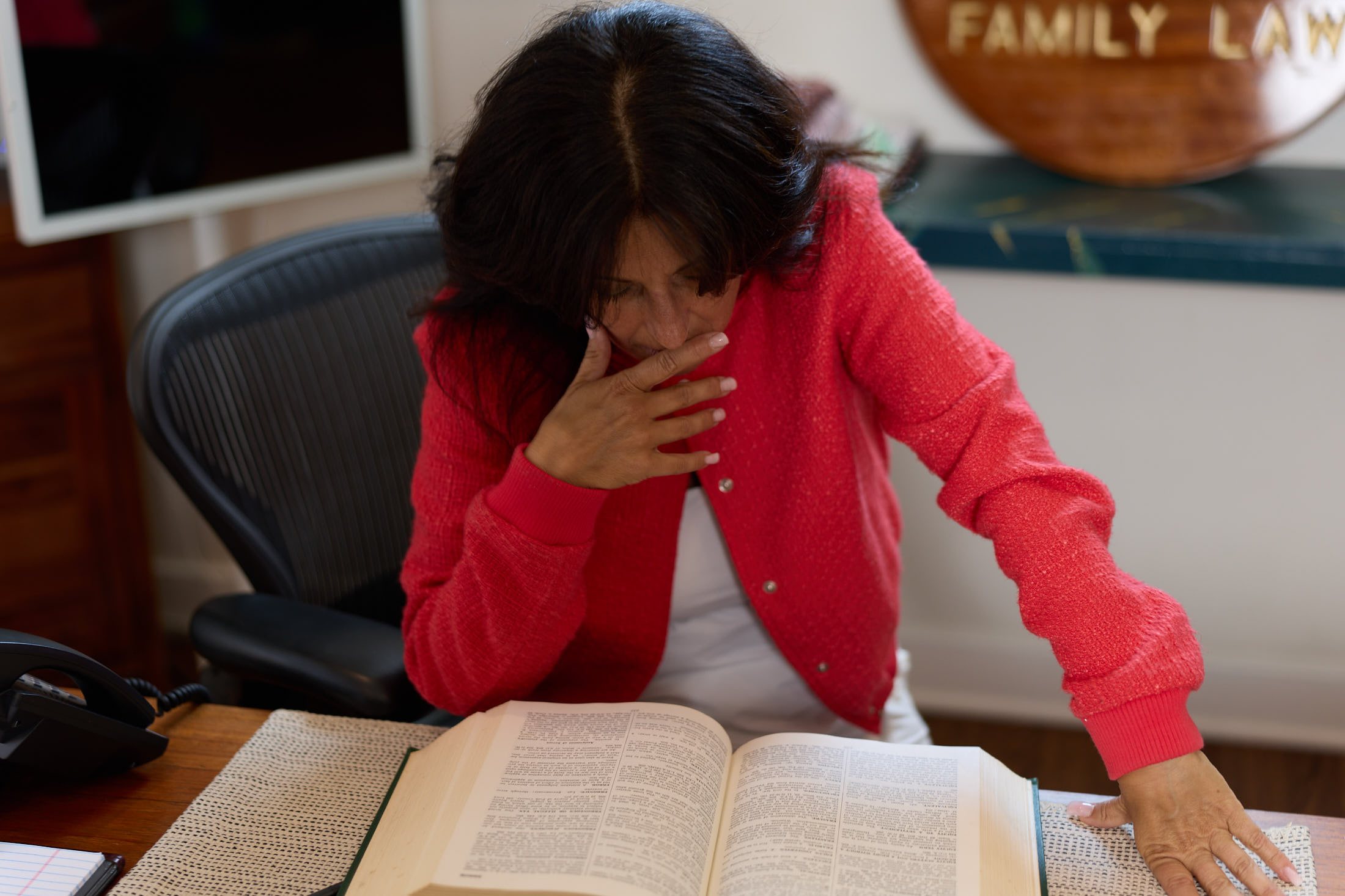 Attorney Tara J. Galbo reading a legal reference volume at her desk in Milford, Connecticut