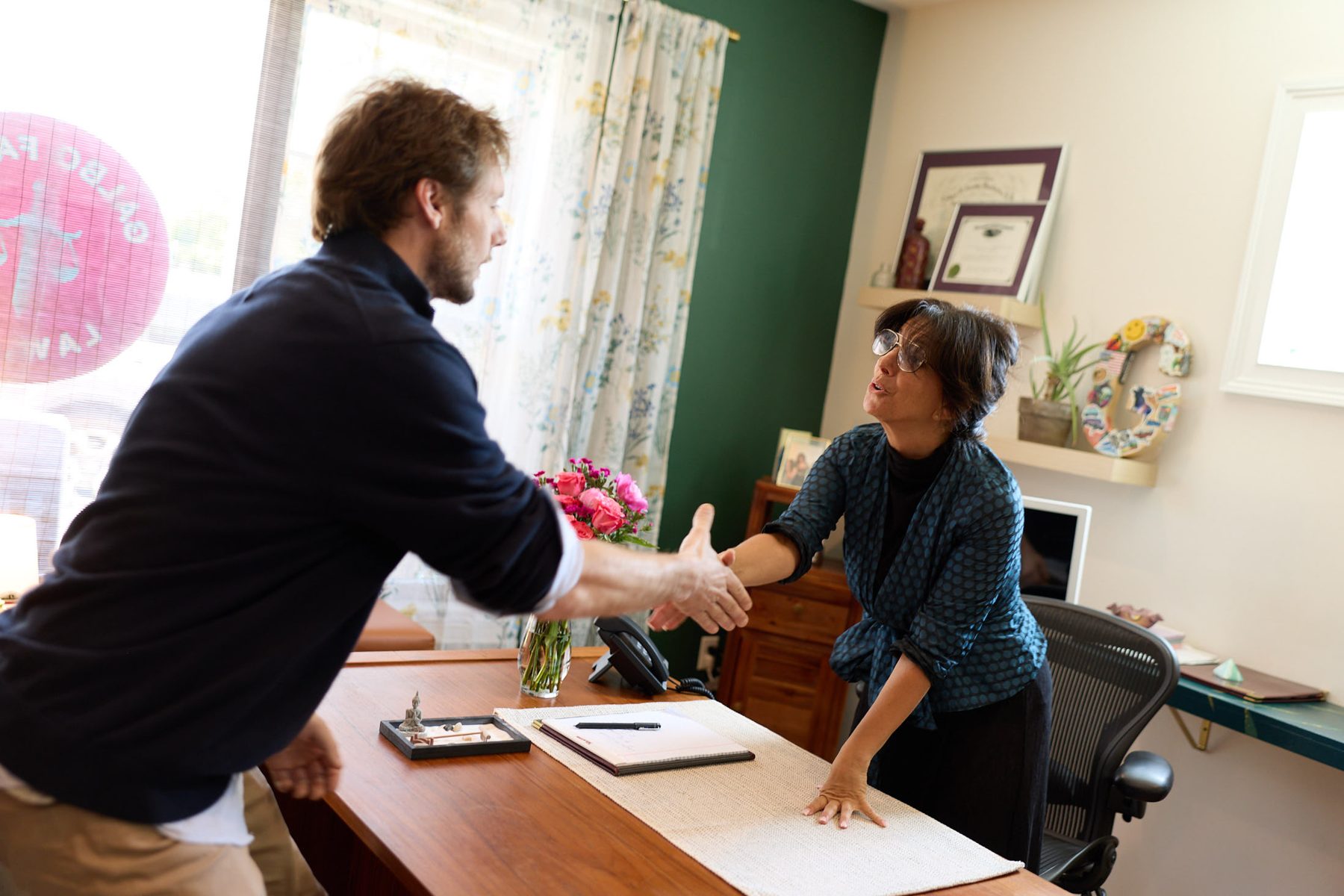 Attorney Tara J. Galbo greeting a client across the desk at her Milford, Connecticut office