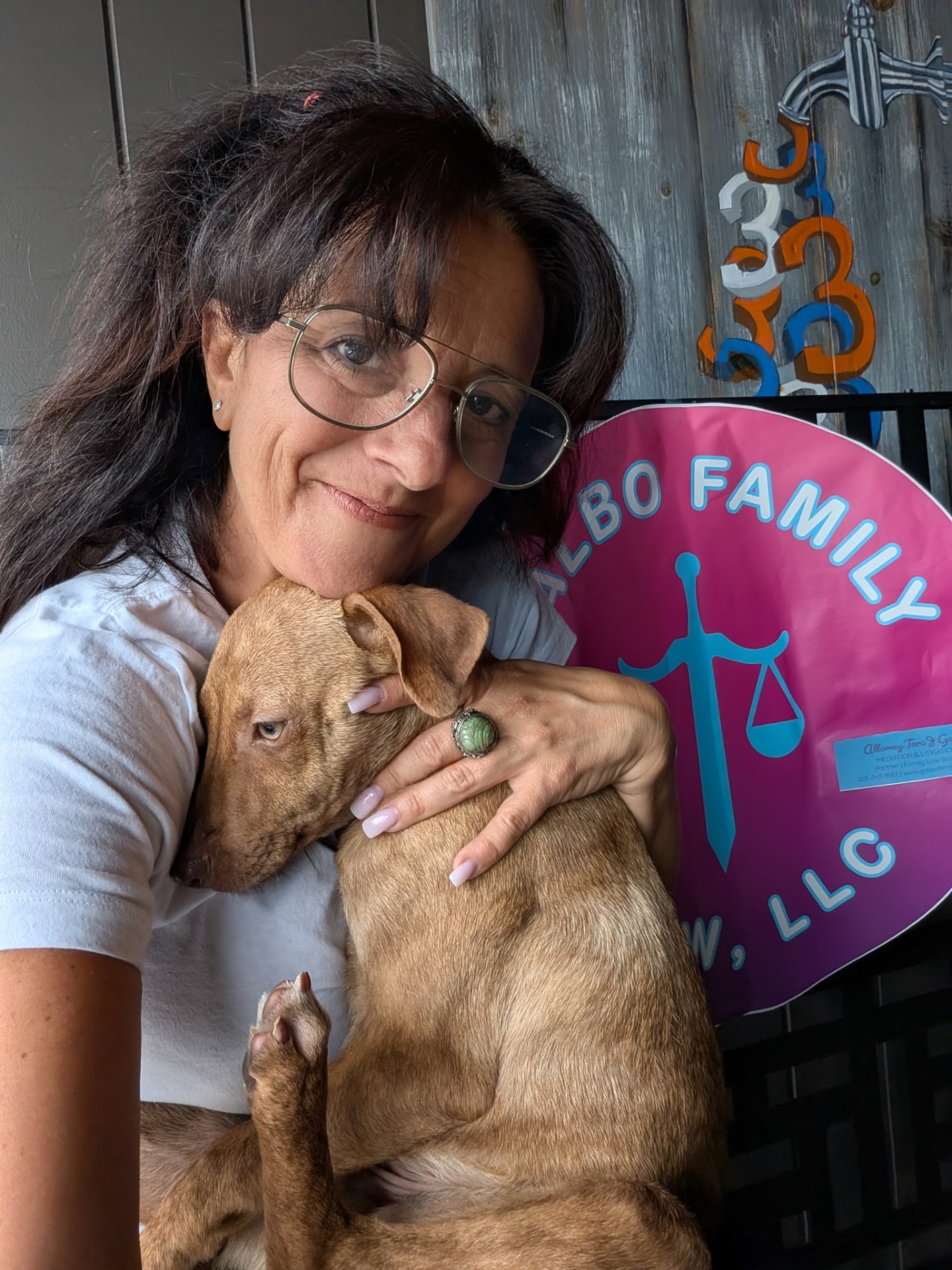 Attorney Tara J. Galbo with a rescue puppy at a Where the Love Is Animal Rescue adoption event